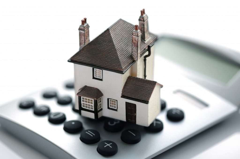 a miniature house and a calculator