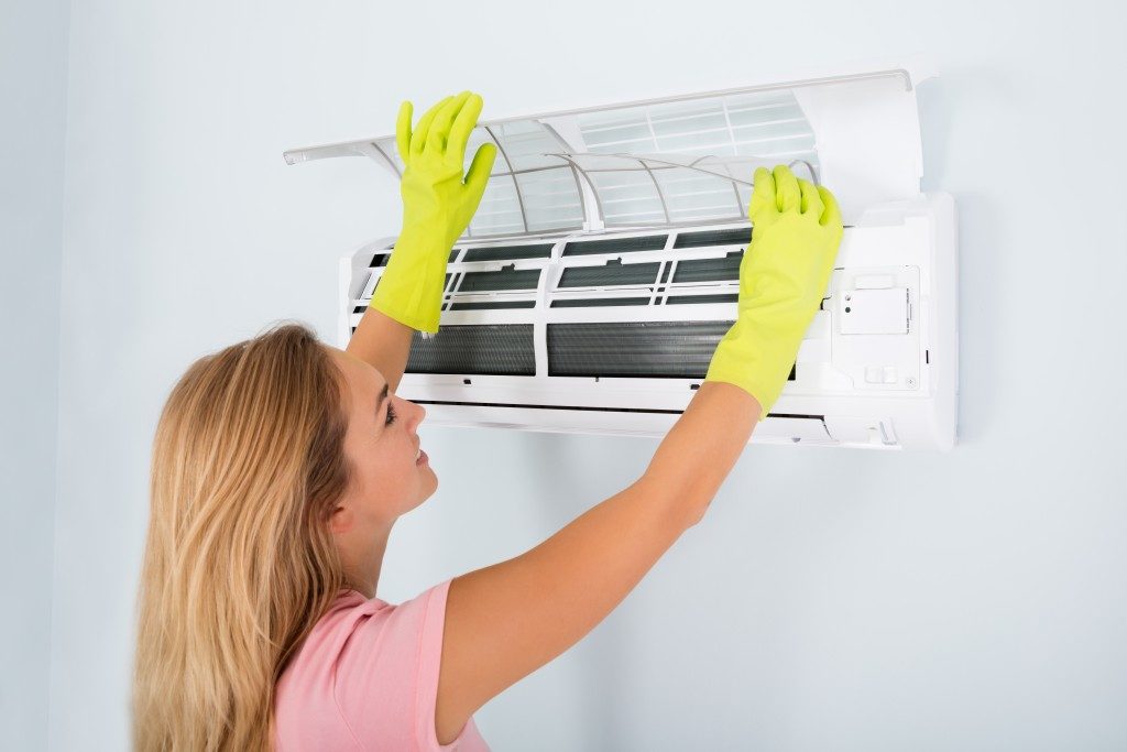 woman cleaning aircon