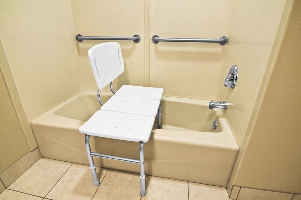 bathing chair and grab bar in the bathroom for elders