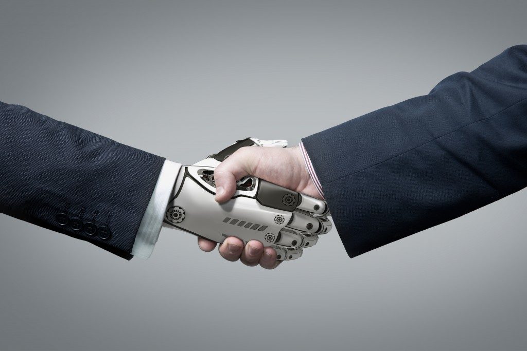 Handshake between robot and human concept