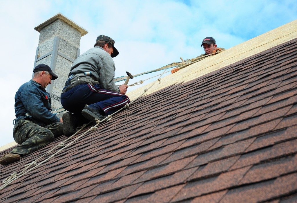 Workers installing roofing