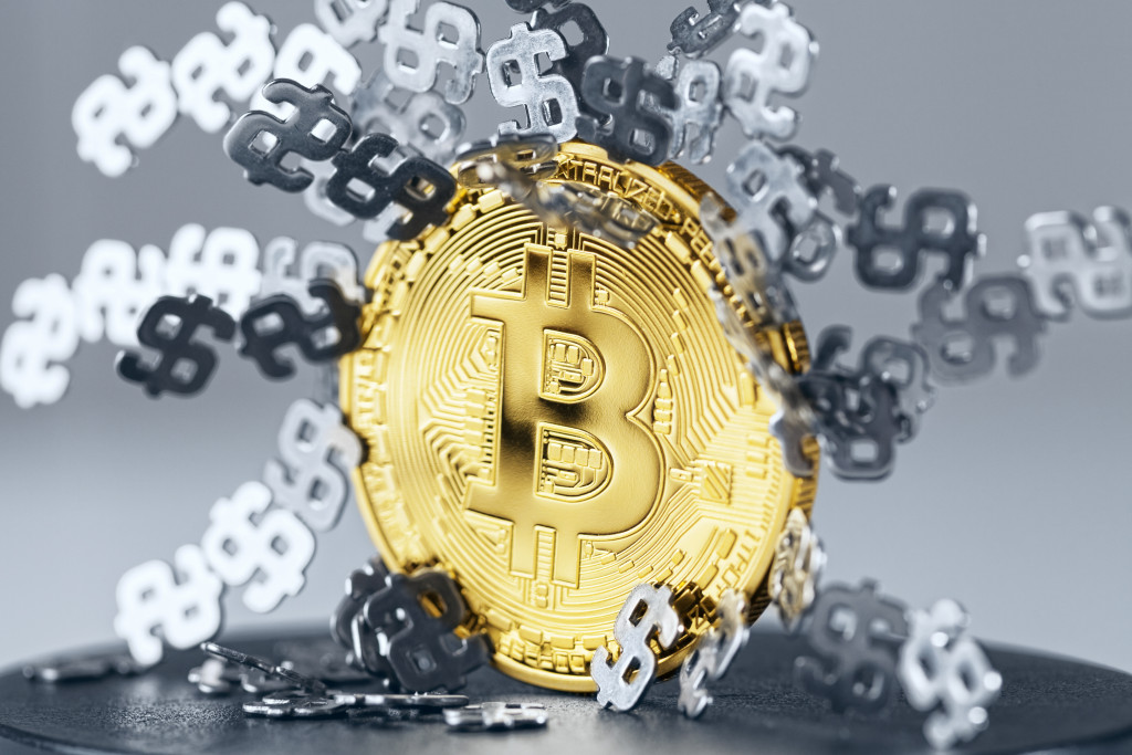 bitcoin icon with usd icons around it