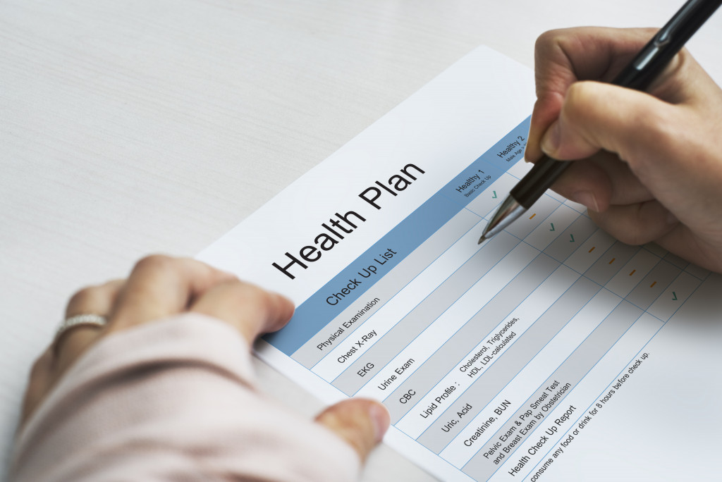woman signing a health insurance plan