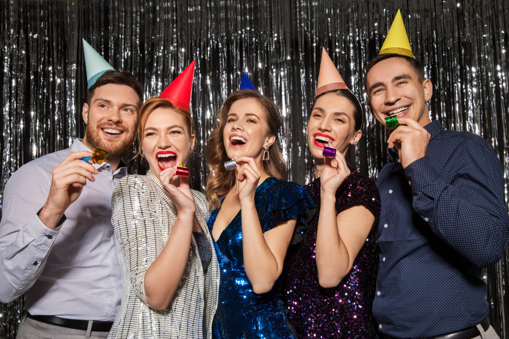Employees wearing party hats while having fun during an office party