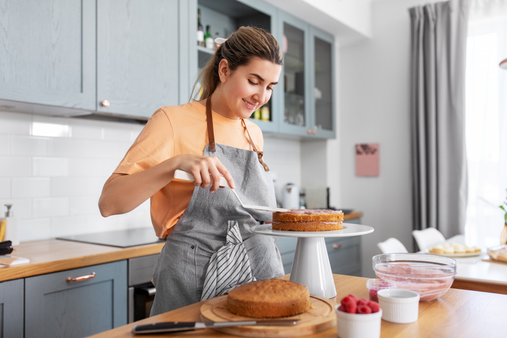 culinary concept shown woman baking and cooking cake at home