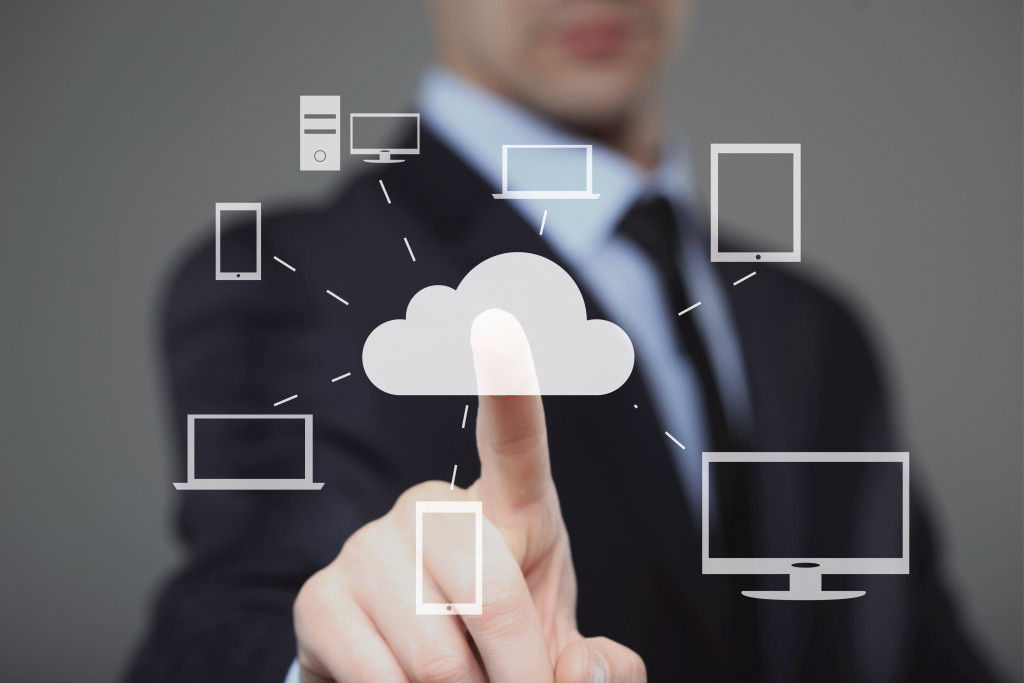 a businessman choosing a cloud computing icon in a screen graphics