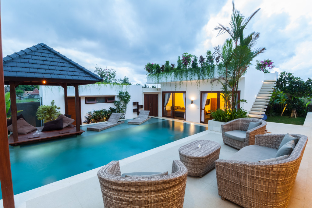 modern villa outdoor with pool and gazebo at sunset