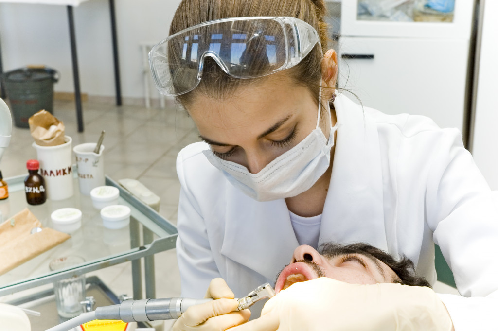 A dentist cleaning a patient's teeth