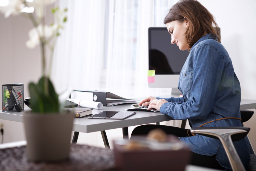woman sitting computing expenses
