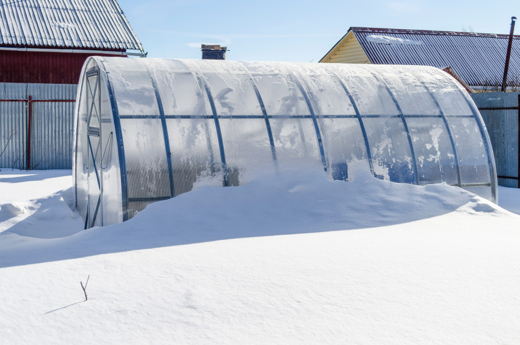 deep winter greenhouse in a snow-covered area