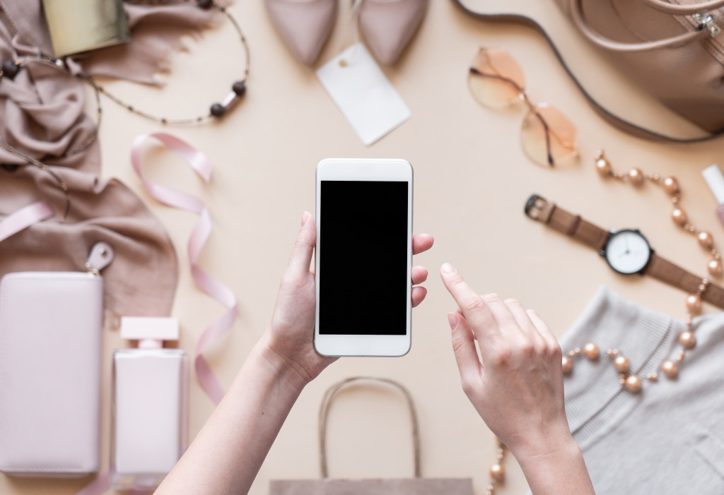 phone over a bunch of neutral-colored elegant accessories for work