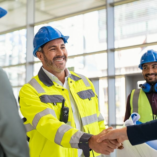 construction manager and supervisor shaking hands