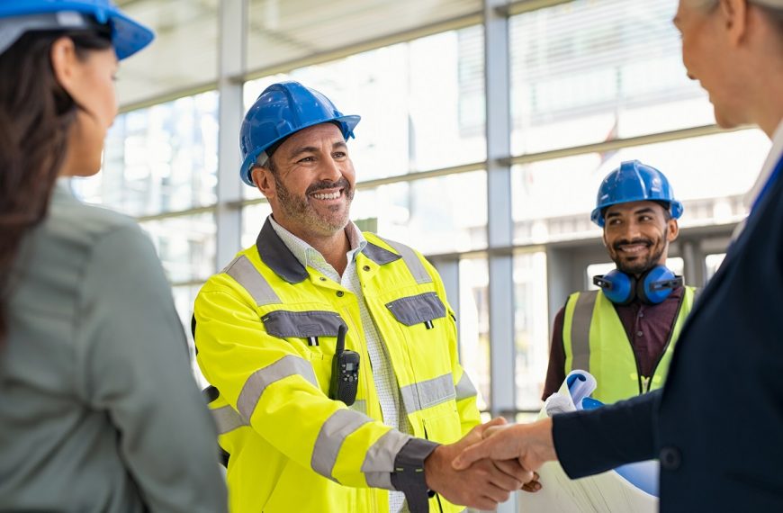 construction manager and supervisor shaking hands